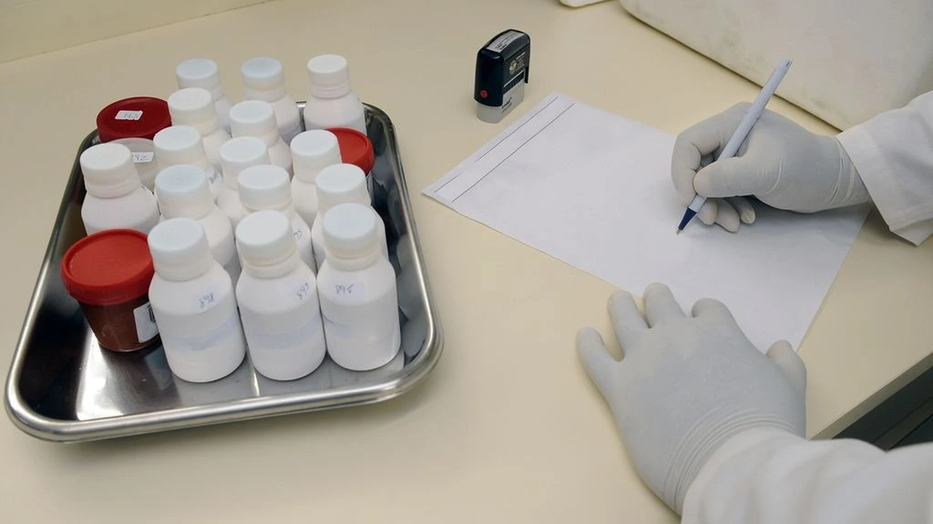 Batch records and certificates of analysis on a stainless-steel inspection table