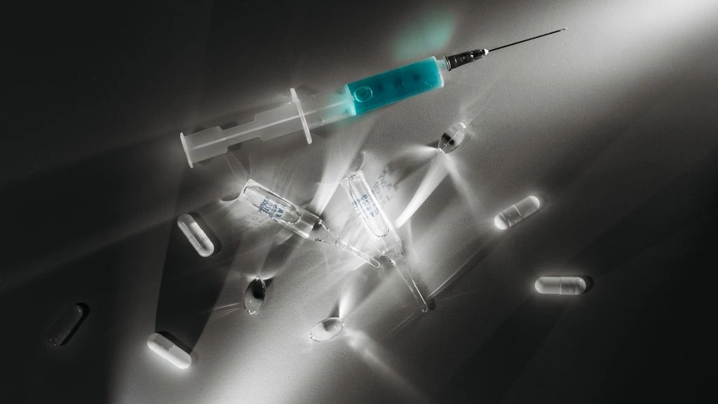 Certificate of Analysis, FDA approval letter, and a sterile vial arranged on a neutral desk