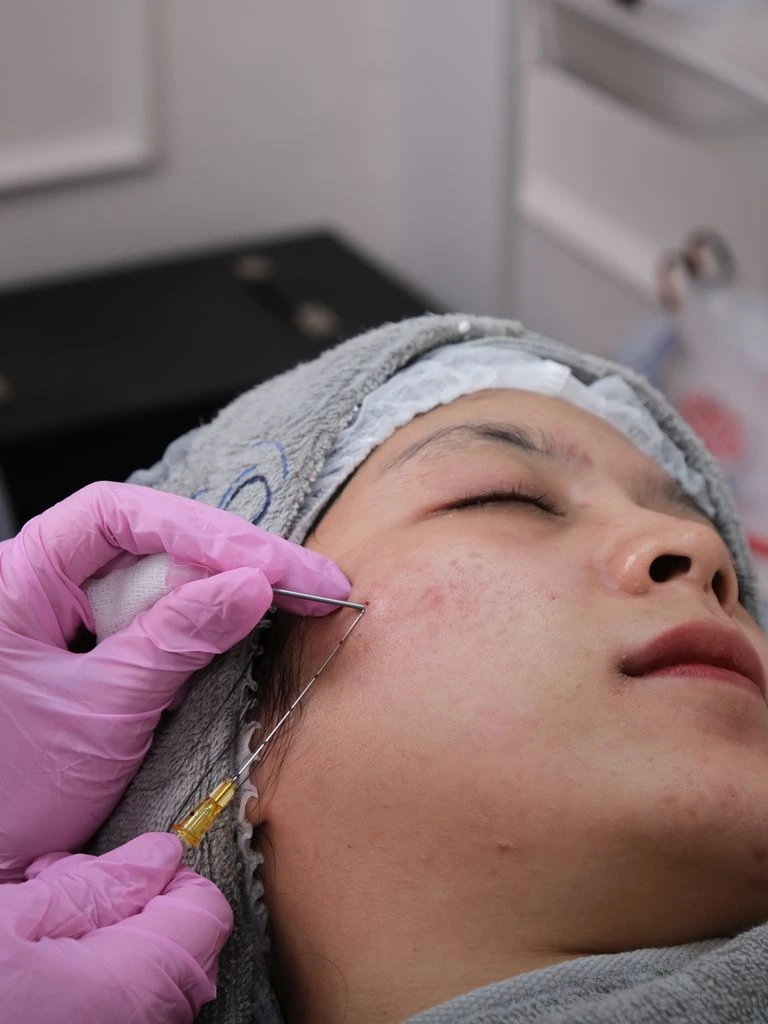 Skin booster ampoule kit on neutral backdrop